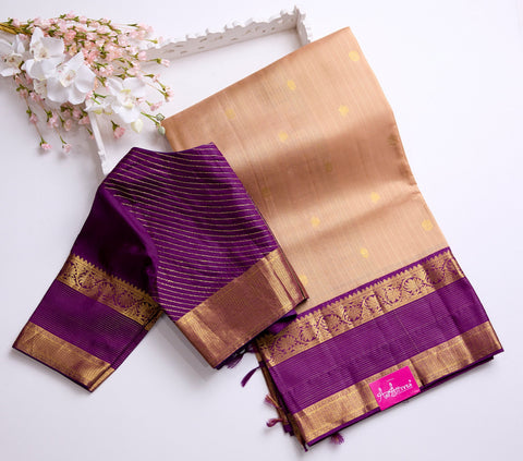 Beige body with golden motifs with rich purple Border Kanchipattu Saree