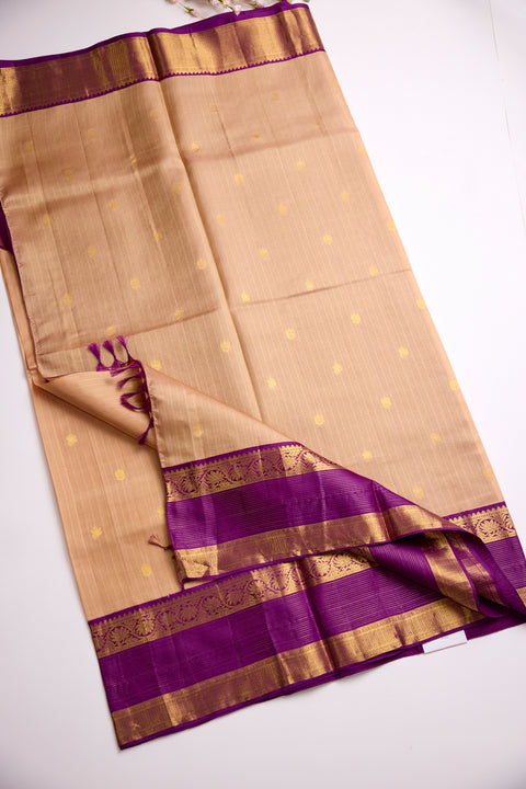 Beige body with golden motifs with rich purple Border Kanchipattu Saree