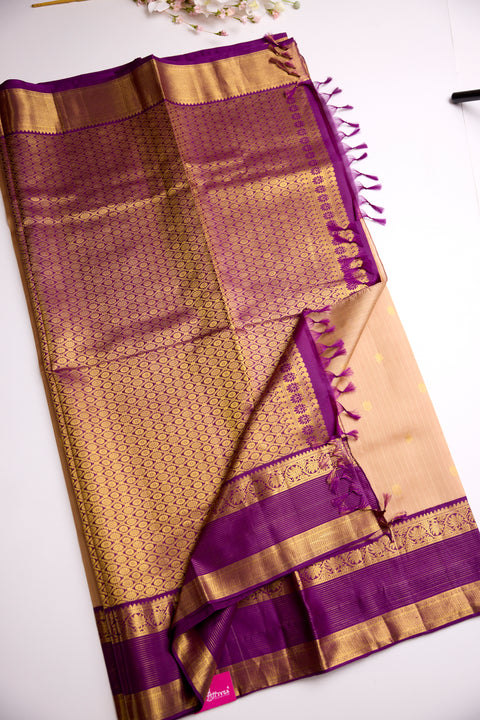 Beige body with golden motifs with rich purple Border Kanchipattu Saree