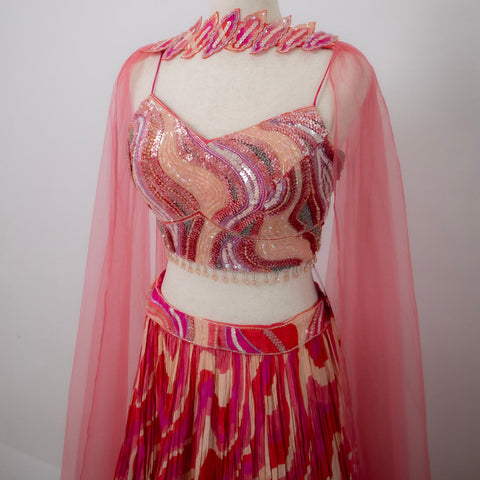Pink and red patterned outfit with a sheer overlay 