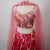 Pink and red patterned outfit with a sheer overlay 